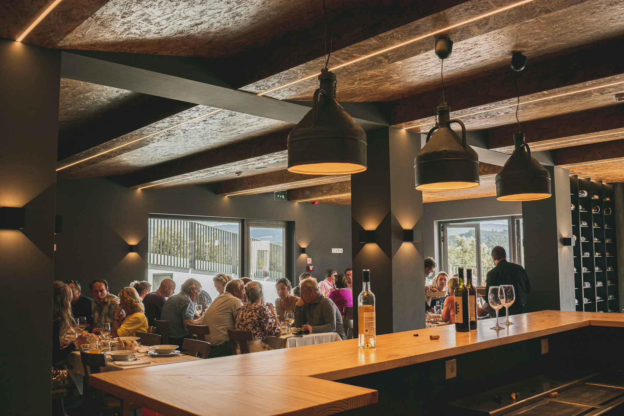 A restaurant full of people dining in a cozy environment